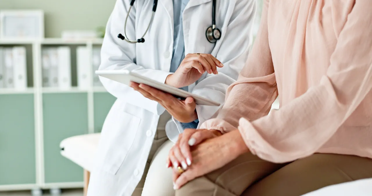 Doctor and patient sitting in clinic having discussion