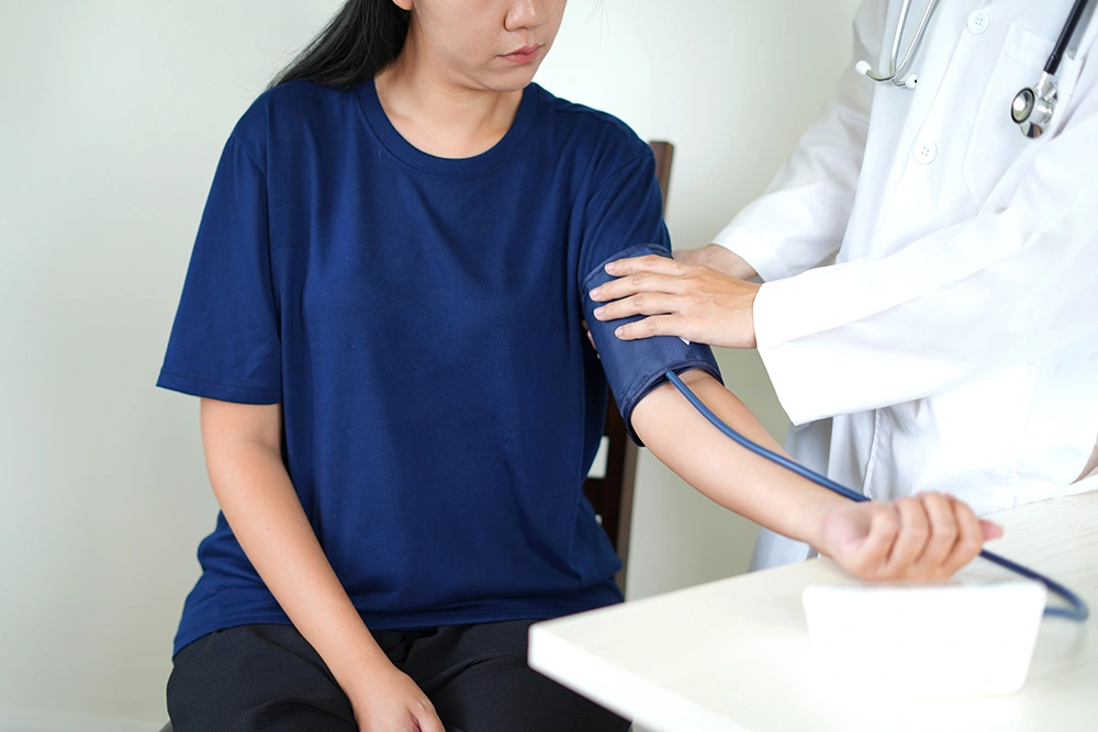 A woman receiving a check-up at a clinic